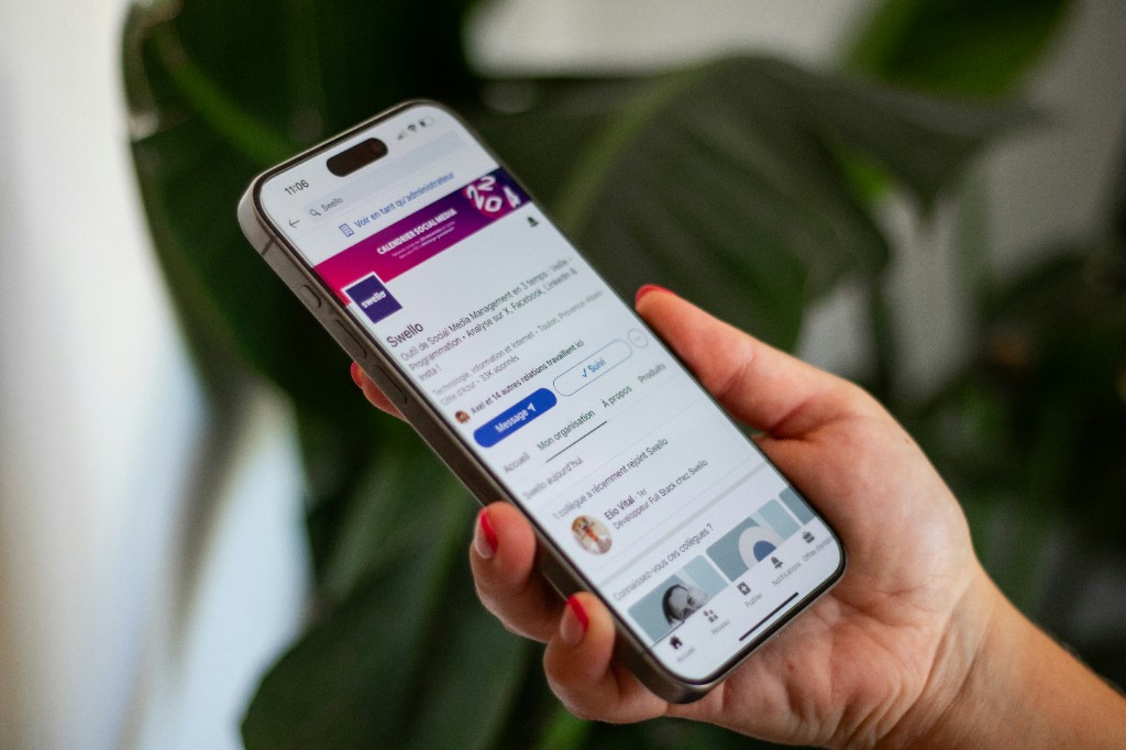 Person scrolling LinkedIn on phone